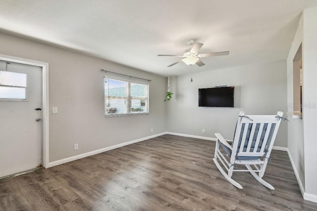 entryway featuring baseboards, a ceiling fan, and wood finished floors
