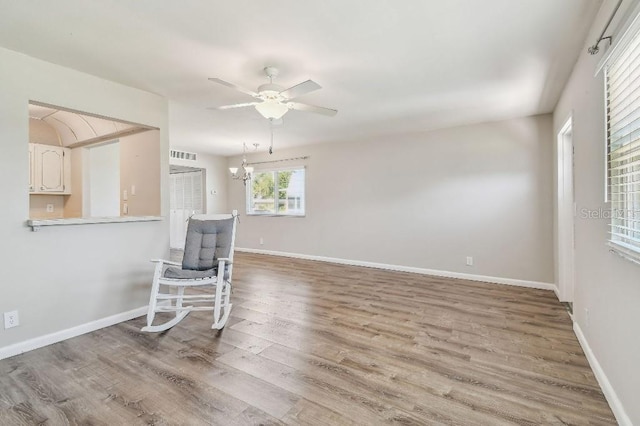 spare room with baseboards, a ceiling fan, and wood finished floors