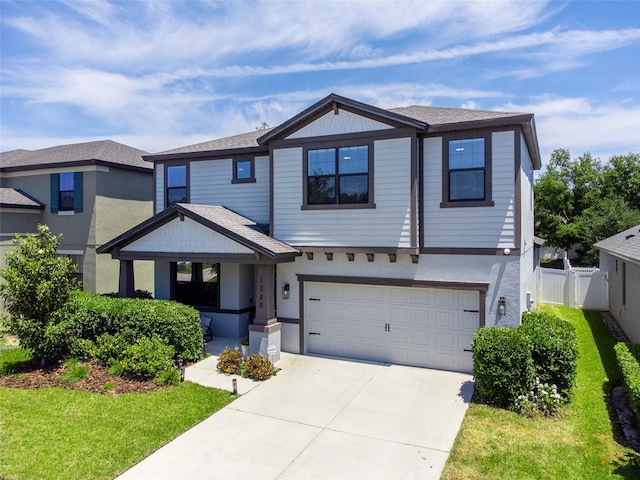 craftsman inspired home with fence, covered porch, a front yard, concrete driveway, and an attached garage