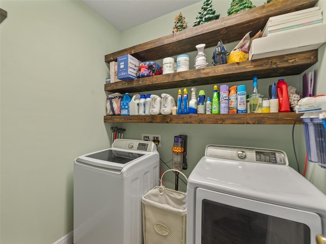 washroom featuring washing machine and clothes dryer and laundry area