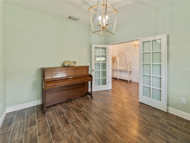 interior space with an inviting chandelier, visible vents, baseboards, dark wood-type flooring, and french doors