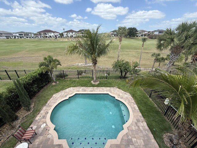 view of swimming pool with a fenced in pool, a yard, and a fenced backyard