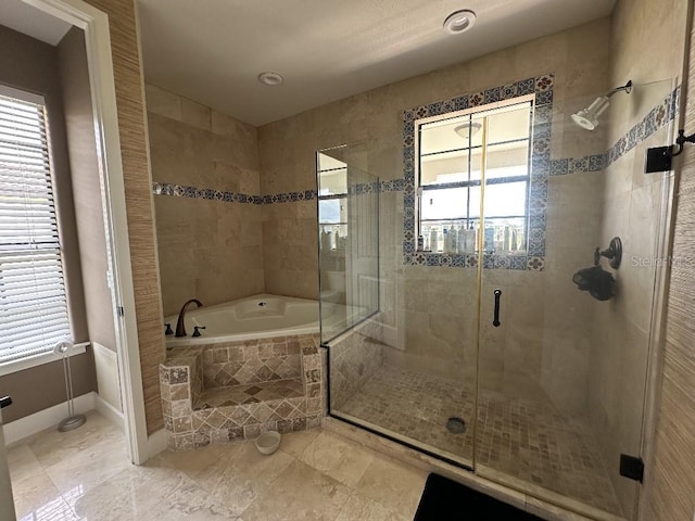 1056 Castle Pines Ct, Reunion, FL 34747 - bathroom featuring plenty of natural light, a garden tub, a stall shower, and baseboards