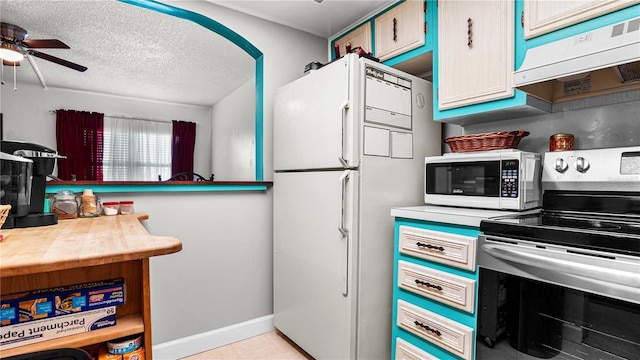 kitchen with baseboards, light countertops, ceiling fan, and white appliances