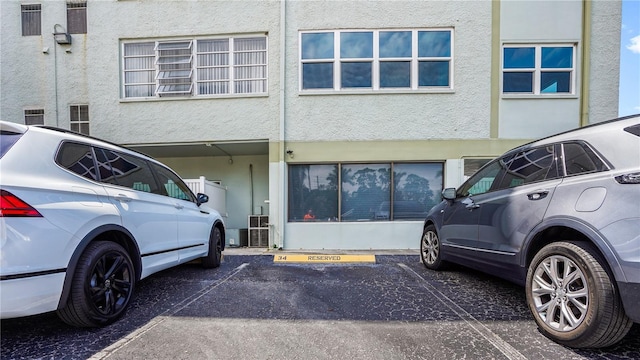 exterior space featuring uncovered parking and stucco siding