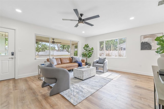 living area featuring a ceiling fan, light wood-style floors, baseboards, and recessed lighting