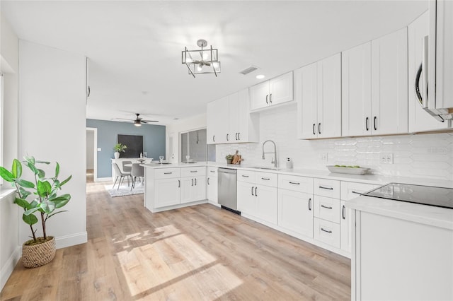 kitchen with a sink, dishwasher, a peninsula, ceiling fan, and tasteful backsplash