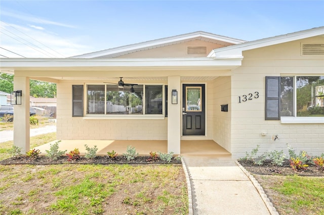 entrance to property featuring ceiling fan