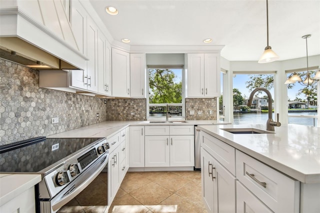 kitchen with a sink, a wealth of natural light, custom range hood, and electric stove