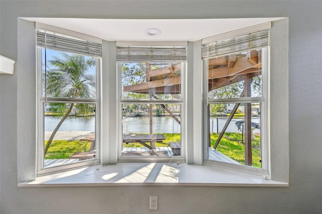 interior details featuring a textured wall and a water view