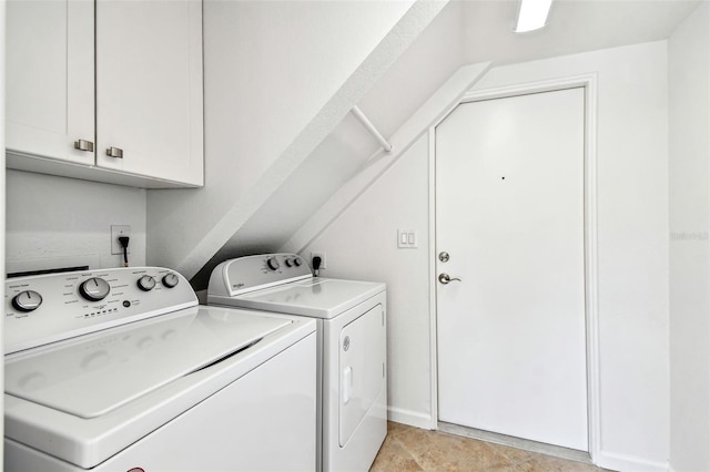 washroom with cabinet space and washer and clothes dryer