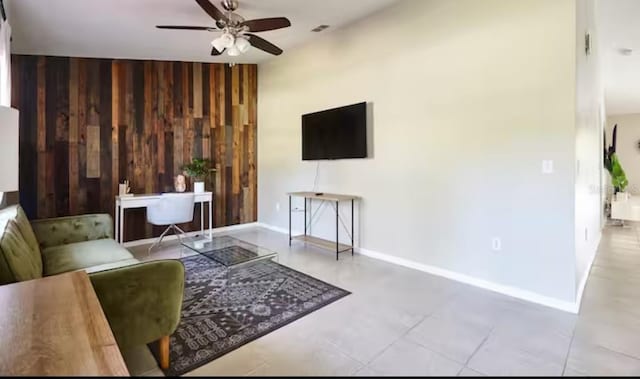 728 Alford St SE, Palm Bay, FL 32909 - living area with baseboards, wood walls, and ceiling fan