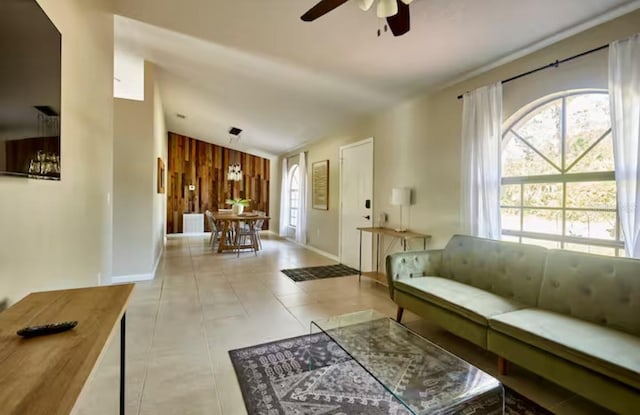 728 Alford St SE, Palm Bay, FL 32909 - living room with wooden walls, a ceiling fan, baseboards, and vaulted ceiling