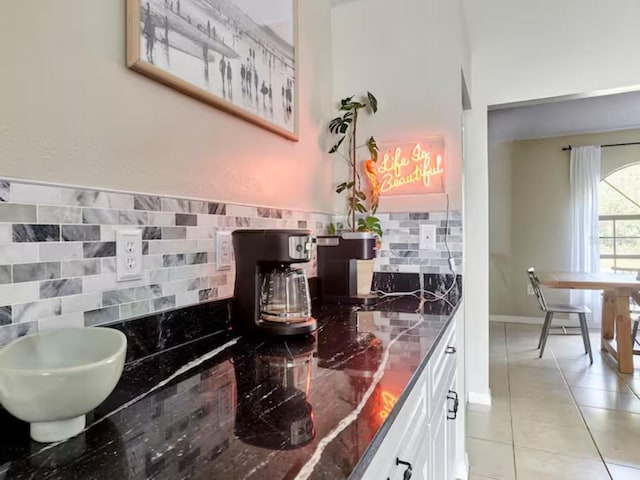 728 Alford St SE, Palm Bay, FL 32909 - interior space with white cabinets, decorative backsplash, and light tile patterned floors