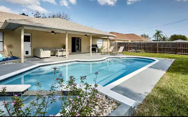 728 Alford St SE, Palm Bay, FL 32909 - view of swimming pool with a lawn, ceiling fan, a fenced backyard, and a patio area