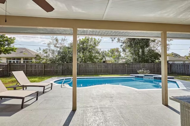 728 Alford St SE, Palm Bay, FL 32909 - view of swimming pool featuring a fenced backyard, a ceiling fan, a patio area, and a pool with connected hot tub