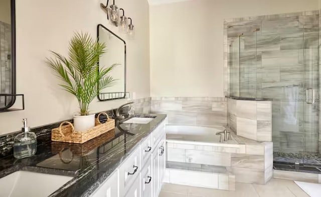 728 Alford St SE, Palm Bay, FL 32909 - full bathroom featuring a garden tub, double vanity, tile patterned floors, a shower stall, and a sink