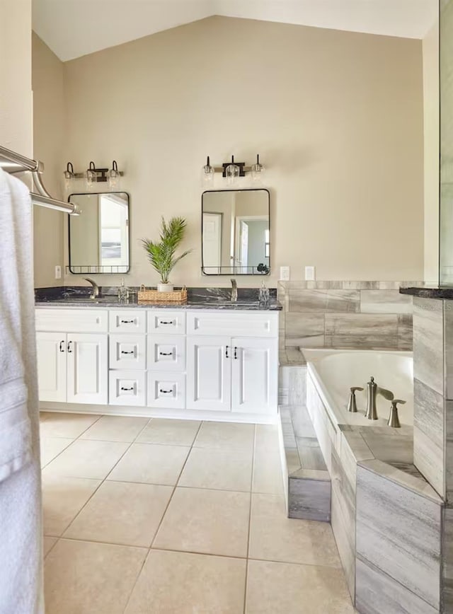 728 Alford St SE, Palm Bay, FL 32909 - full bathroom featuring double vanity, a garden tub, tile patterned flooring, a sink, and lofted ceiling