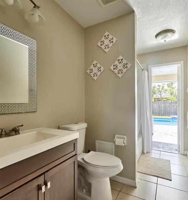 728 Alford St SE, Palm Bay, FL 32909 - bathroom featuring tile patterned flooring, shower / bath combo, vanity, baseboards, and toilet
