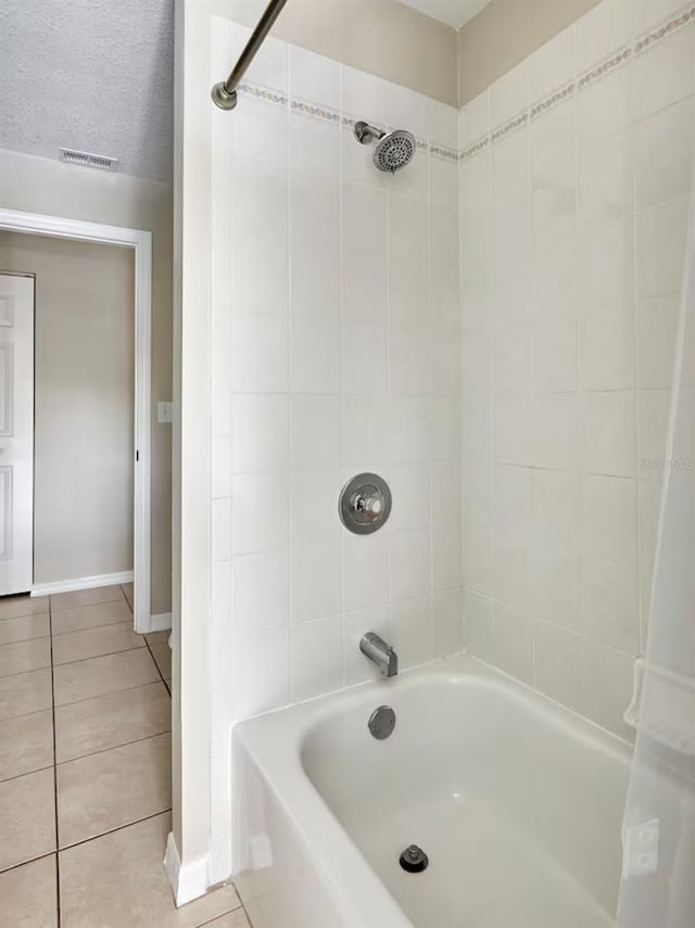 728 Alford St SE, Palm Bay, FL 32909 - bathroom with tile patterned floors, baseboards, shower / bathing tub combination, and visible vents