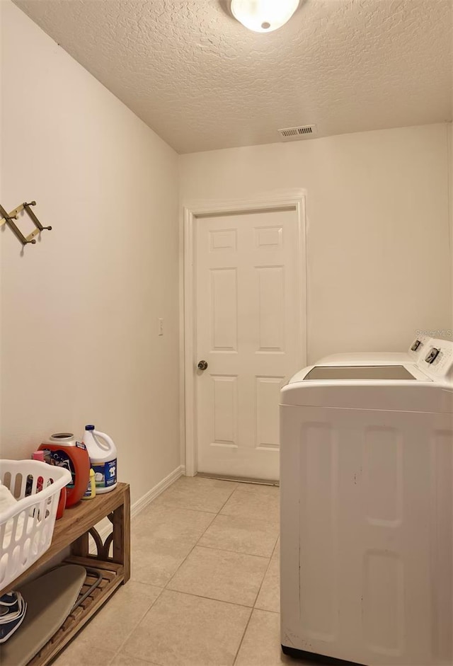 728 Alford St SE, Palm Bay, FL 32909 - laundry area with laundry area, a textured ceiling, visible vents, baseboards, and light tile patterned flooring