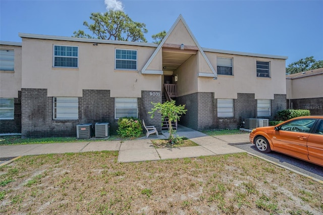 9031 Westchester Cir Unit 128, Tampa, FL 33604 - multi unit property featuring central AC, brick siding, stucco siding, stairway, and a front yard