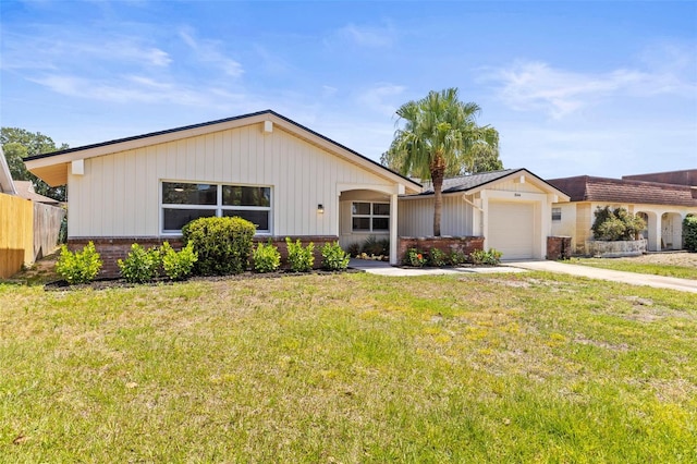 ranch-style house featuring fence, an attached garage, a front lawn, brick siding, and driveway