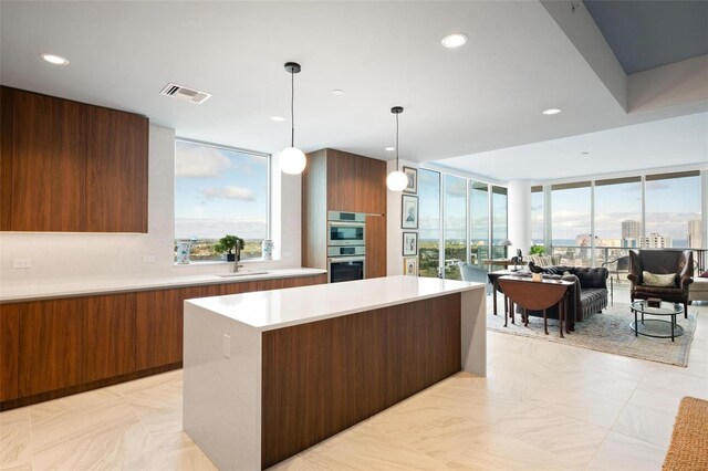 777 3rd Ave N Unit 1403, Saint Petersburg, FL 33701 - kitchen featuring a sink, double oven, light countertops, plenty of natural light, and modern cabinets