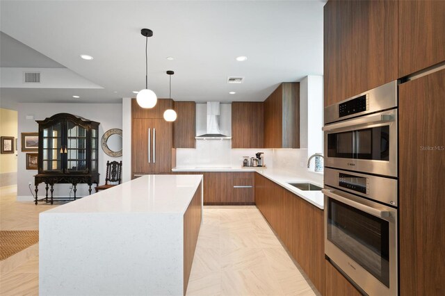 777 3rd Ave N Unit 1403, Saint Petersburg, FL 33701 - kitchen with visible vents, wall chimney exhaust hood, modern cabinets, and a kitchen island