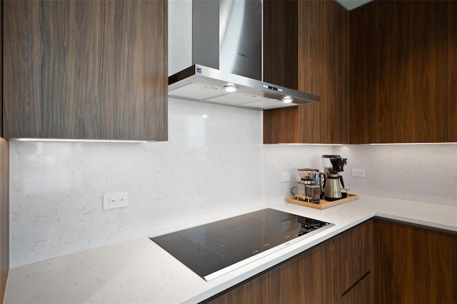 777 3rd Ave N Unit 1403, Saint Petersburg, FL 33701 - kitchen featuring wall chimney range hood, dark brown cabinetry, light countertops, black electric cooktop, and modern cabinets