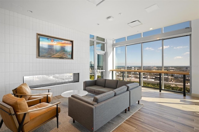 777 3rd Ave N Unit 1403, Saint Petersburg, FL 33701 - living area with expansive windows, a multi sided fireplace, wood finished floors, and tile walls