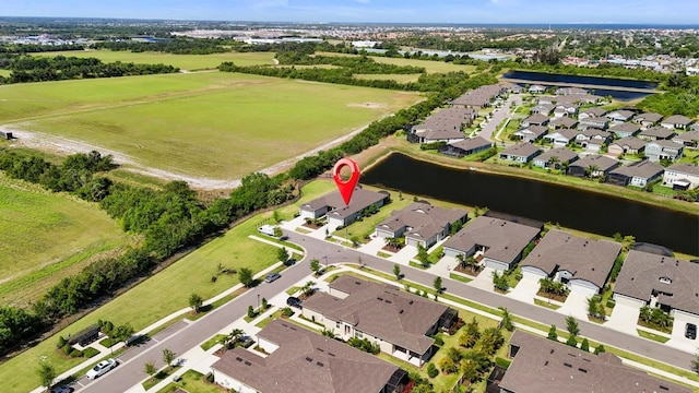 bird's eye view featuring a water view and a residential view