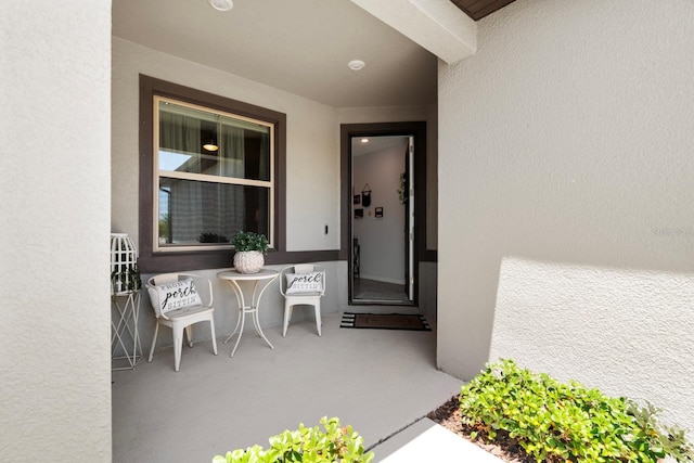 doorway to property featuring stucco siding