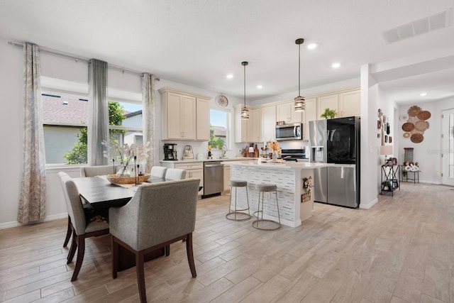 dining area with recessed lighting, baseboards, visible vents, and light wood-type flooring