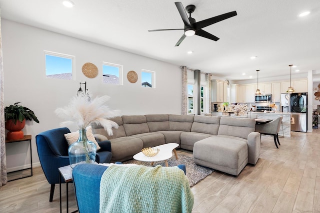 living area with recessed lighting, a ceiling fan, and a healthy amount of sunlight