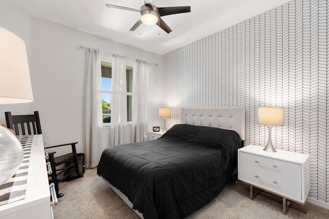 bedroom with ceiling fan, light carpet, and wallpapered walls
