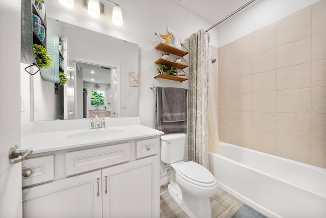 full bath featuring vanity, toilet, and shower / tub combo
