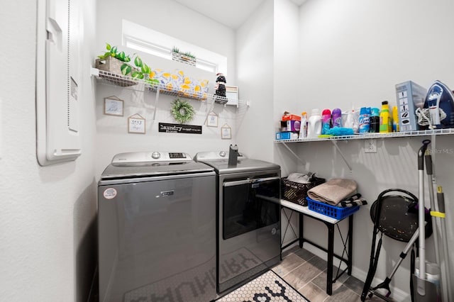 laundry room featuring laundry area, washing machine and dryer, and wood finished floors