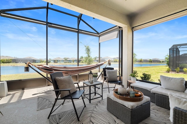sunroom / solarium with a residential view, a water view, an outdoor living space, and a wealth of natural light