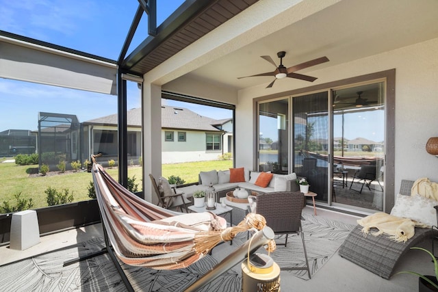 sunroom / solarium featuring ceiling fan and an outdoor hangout area
