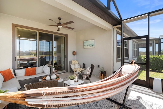 sunroom / solarium with ceiling fan and an outdoor living space