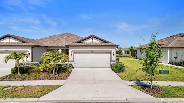 ranch-style home featuring a garage, stucco siding, concrete driveway, and a front yard