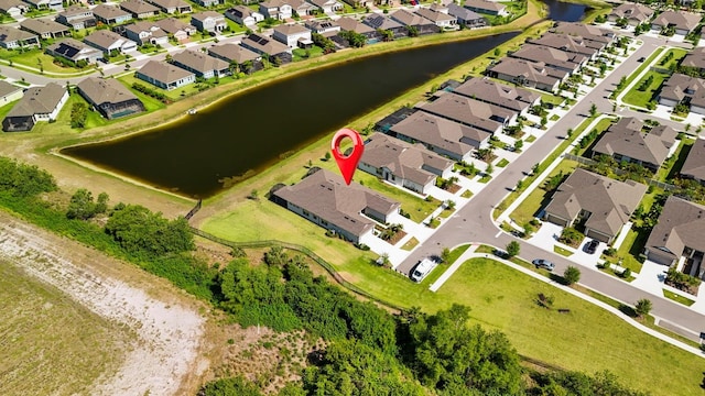 bird's eye view with a residential view and a water view