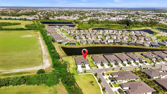 drone / aerial view featuring a water view and a residential view