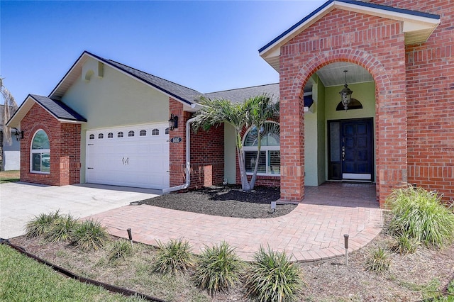 view of front of home featuring brick siding, an attached garage, driveway, and a shingled roof