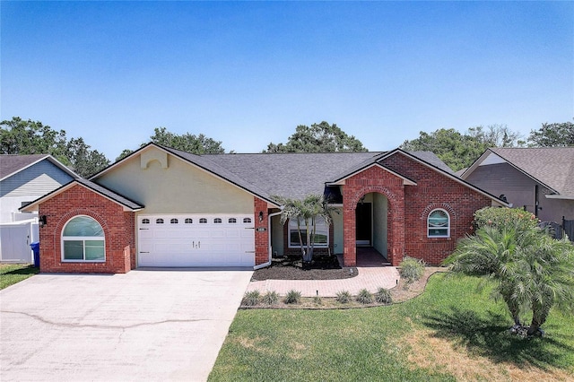 ranch-style house featuring brick siding, driveway, a front yard, and a garage