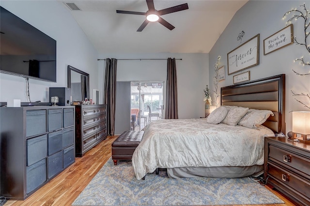 bedroom with a ceiling fan, vaulted ceiling, light wood finished floors, and visible vents
