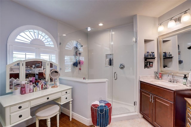 bathroom featuring vanity, baseboards, a shower stall, and recessed lighting