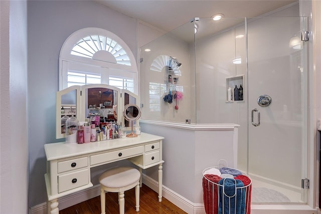 bathroom featuring baseboards, a shower stall, and wood finished floors