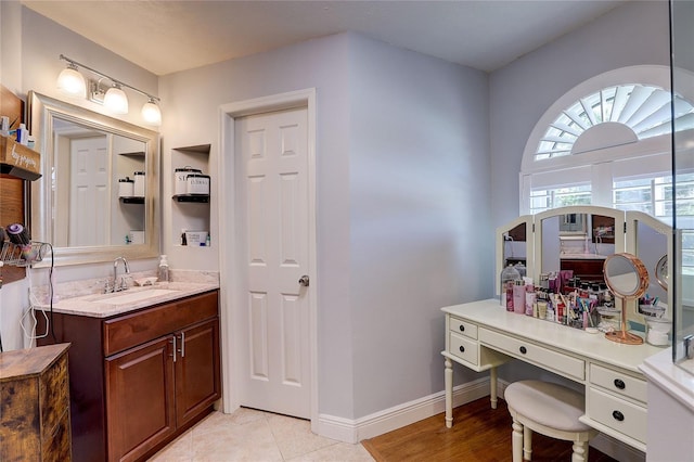 bathroom featuring vanity, baseboards, and tile patterned floors